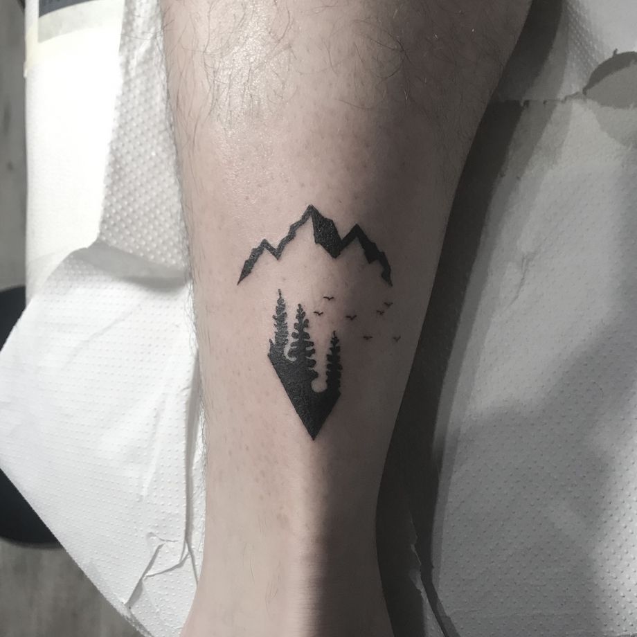 Tatuaje black work de unas montañas